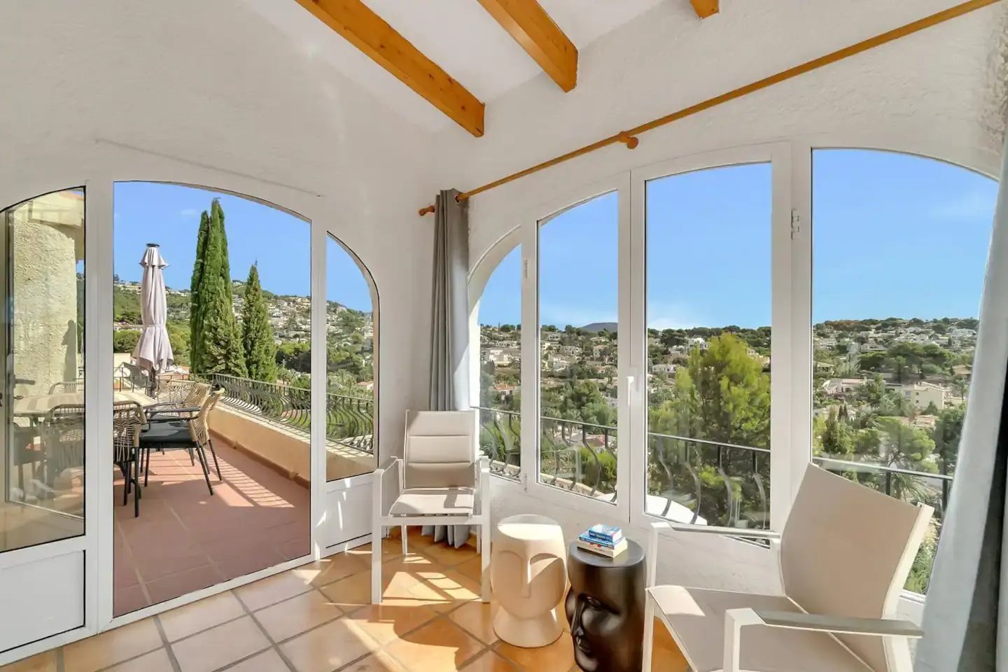 The glazed naya of Casa Carolina with arched windows overlooking the hills
