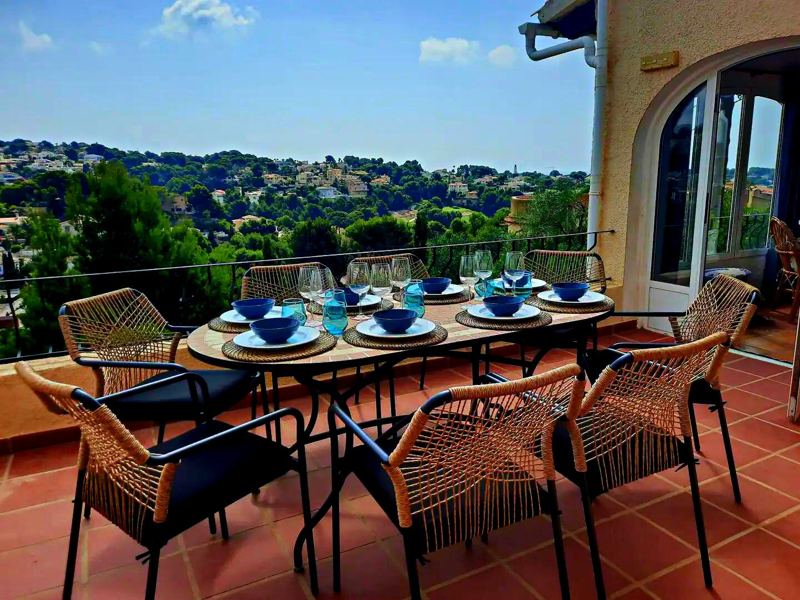 Covered terrace dining area laid for guests